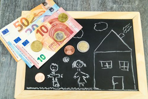 Foto: Tafel mit Kinderzeichnung darauf und Bargeld